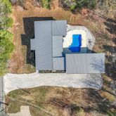 a view of a house with a yard and large tree