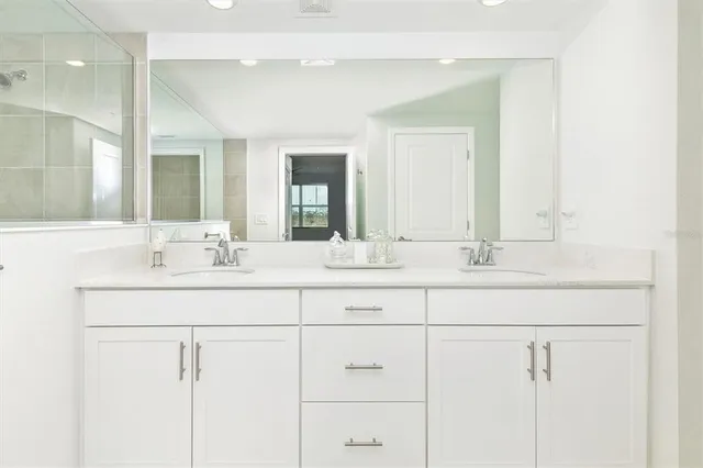 a bathroom with a double vanity sink and a mirror
