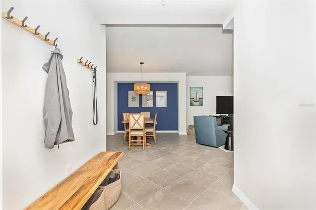 a kitchen that has a lot of cabinets in it and a chandelier