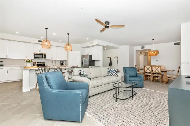 a living room with furniture and floor to ceiling windows