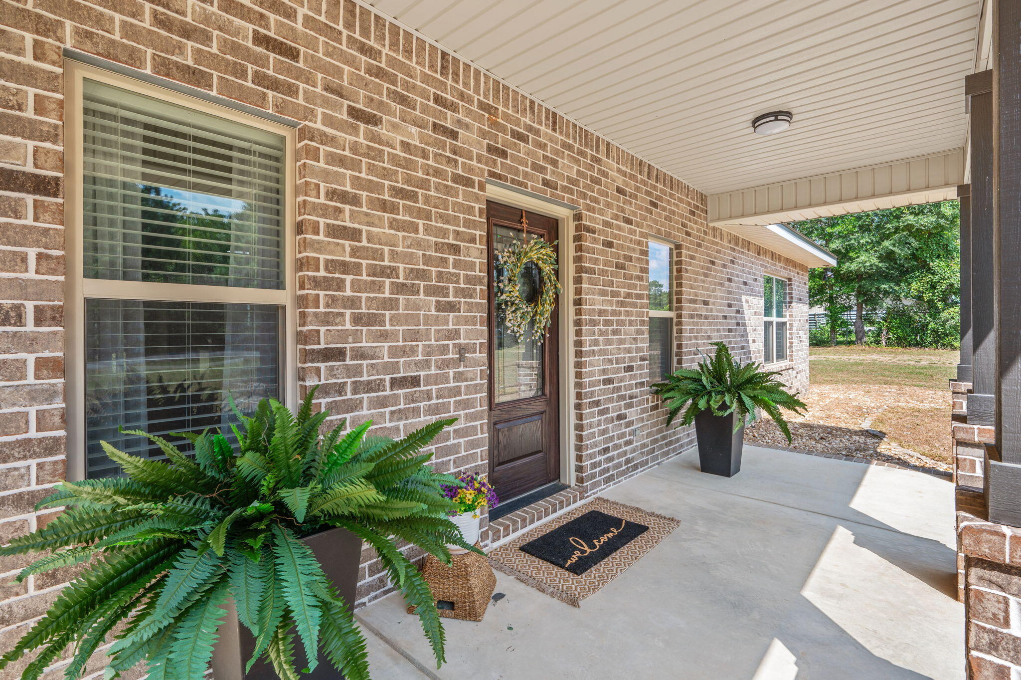 3501 Plympton Road Laurel Hill, FL 32567 - Photo 2 of 26 a potted plant sitting in front of a house
