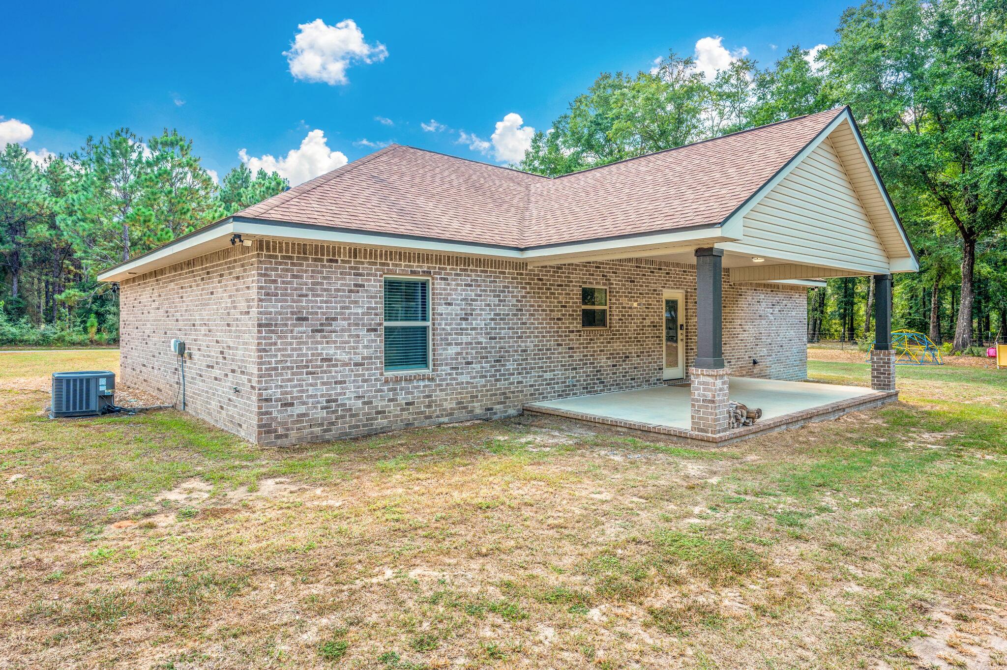 3501 Plympton Road Laurel Hill, FL 32567 - Photo 21 of 26 a view of a house with swimming pool and a yard