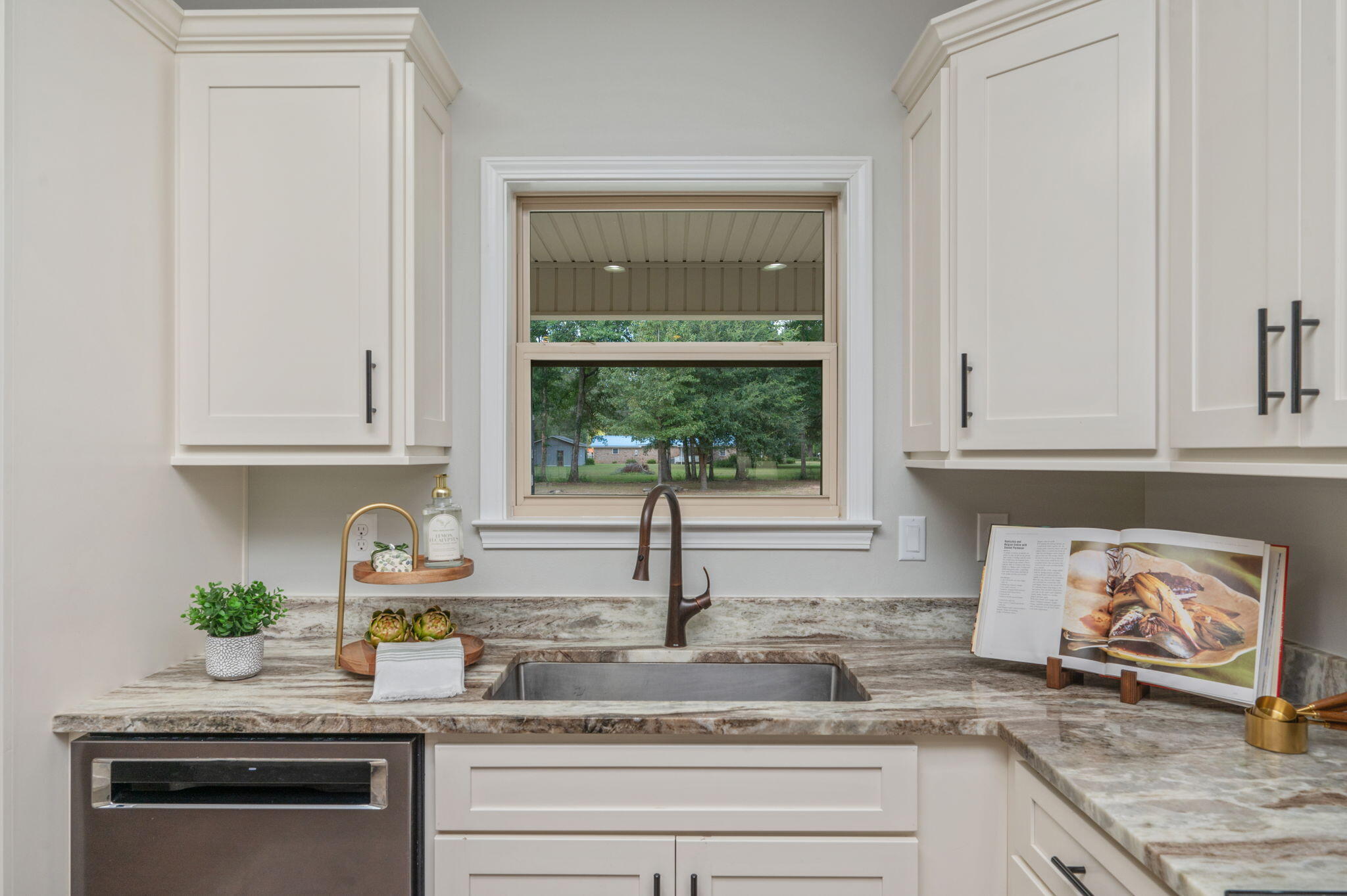 3501 Plympton Road Laurel Hill, FL 32567 - Photo 9 of 26 a kitchen with granite countertop white cabinets and a window