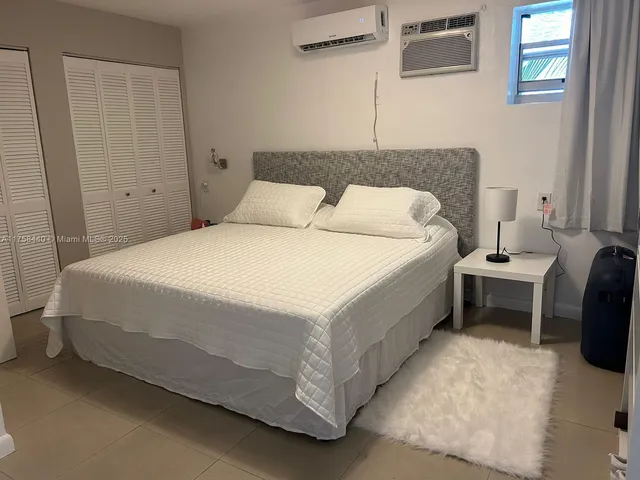 a spacious bedroom with a bed and a table