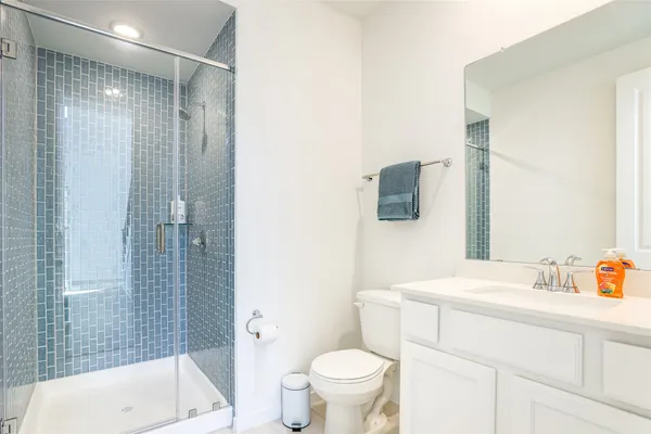 a bathroom with a sink toilet and shower