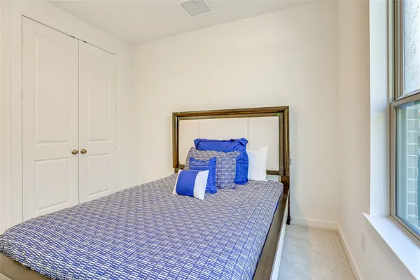 a bedroom with a bed and a mirror