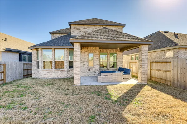 a view of a house with backyard porch and sitting area