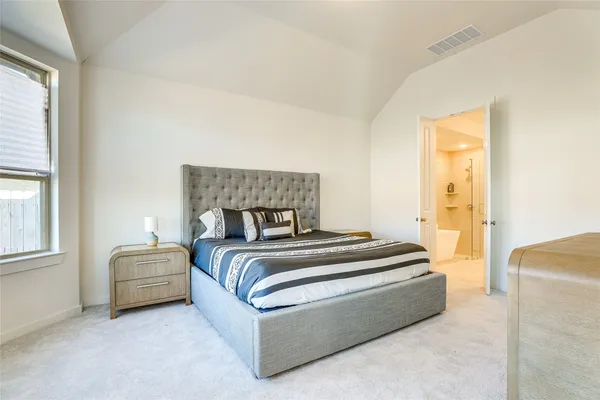 a bedroom with a bed and a couch