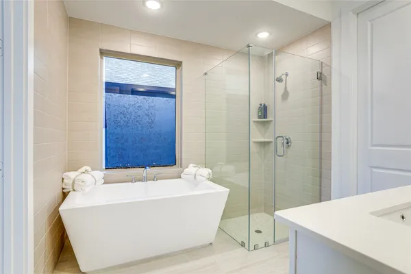 a bathroom with a bathtub and shower