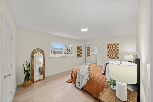 an empty room with wooden floor and window