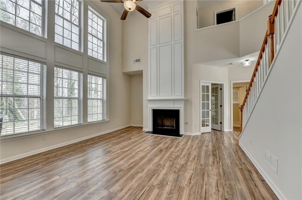 100 Hawnley Trc Northwest Suwanee, GA 30024 - Photo 16 of 58 a view of empty room with wooden floor and fan