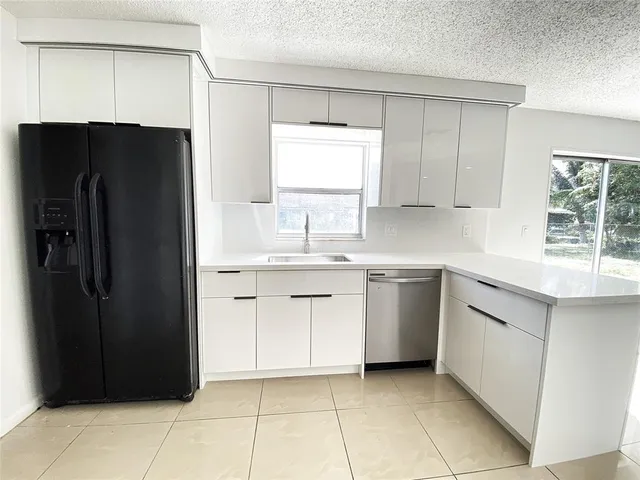 a kitchen with a refrigerator and a sink