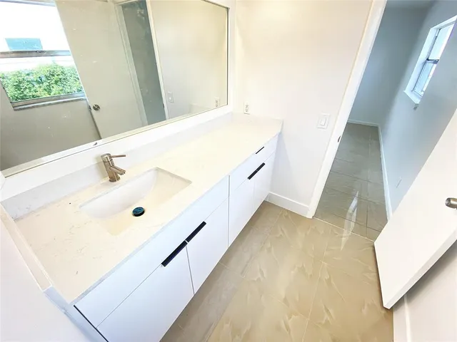 a bathroom with a double vanity sink and mirror