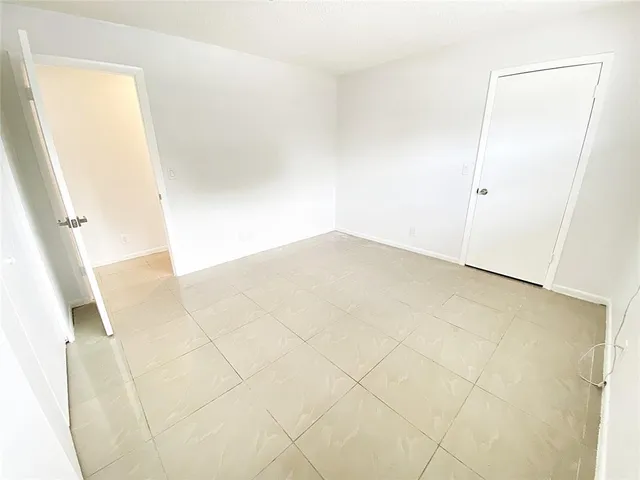 an empty room with wooden floor