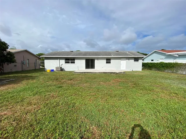 a view of an house with backyard space and balcony