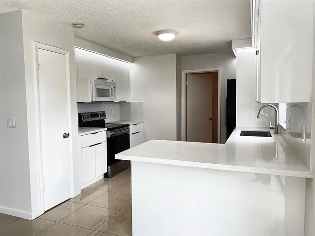 a kitchen with a sink a stove and refrigerator