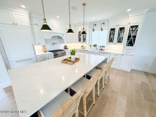 a large kitchen with a table and chairs