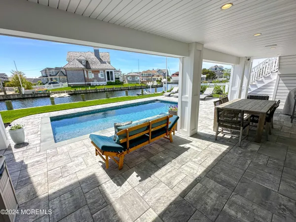a outdoor living space with furniture and a view of pool