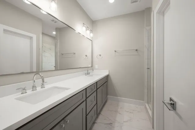a bathroom with a double vanity sink mirror and