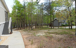 913 Paynes Creek Road, Unit LOT 11 Hartwell, GA 30643 - Photo 14 of 14 a view of a backyard with large trees and wooden fence