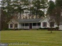 49239 Bennett Drive Ridge, MD 20680 - Photo 1 of 13 a front view of a house with a garden