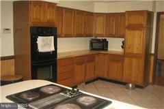 49239 Bennett Drive Ridge, MD 20680 - Photo 3 of 13 a kitchen with a sink and cabinets