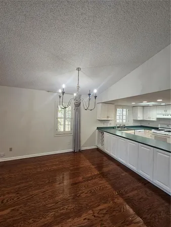 a large kitchen with granite countertop a large counter top and sink