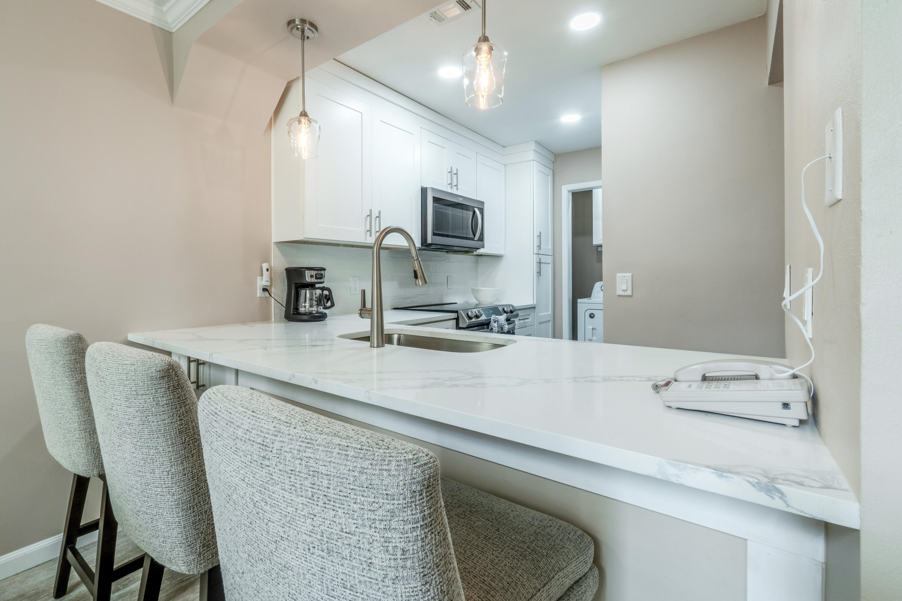 7 Wimbledon Court, Unit 7B Miramar Beach, FL 32550 - Photo 13 of 46 a kitchen with a table chairs sink and cabinets