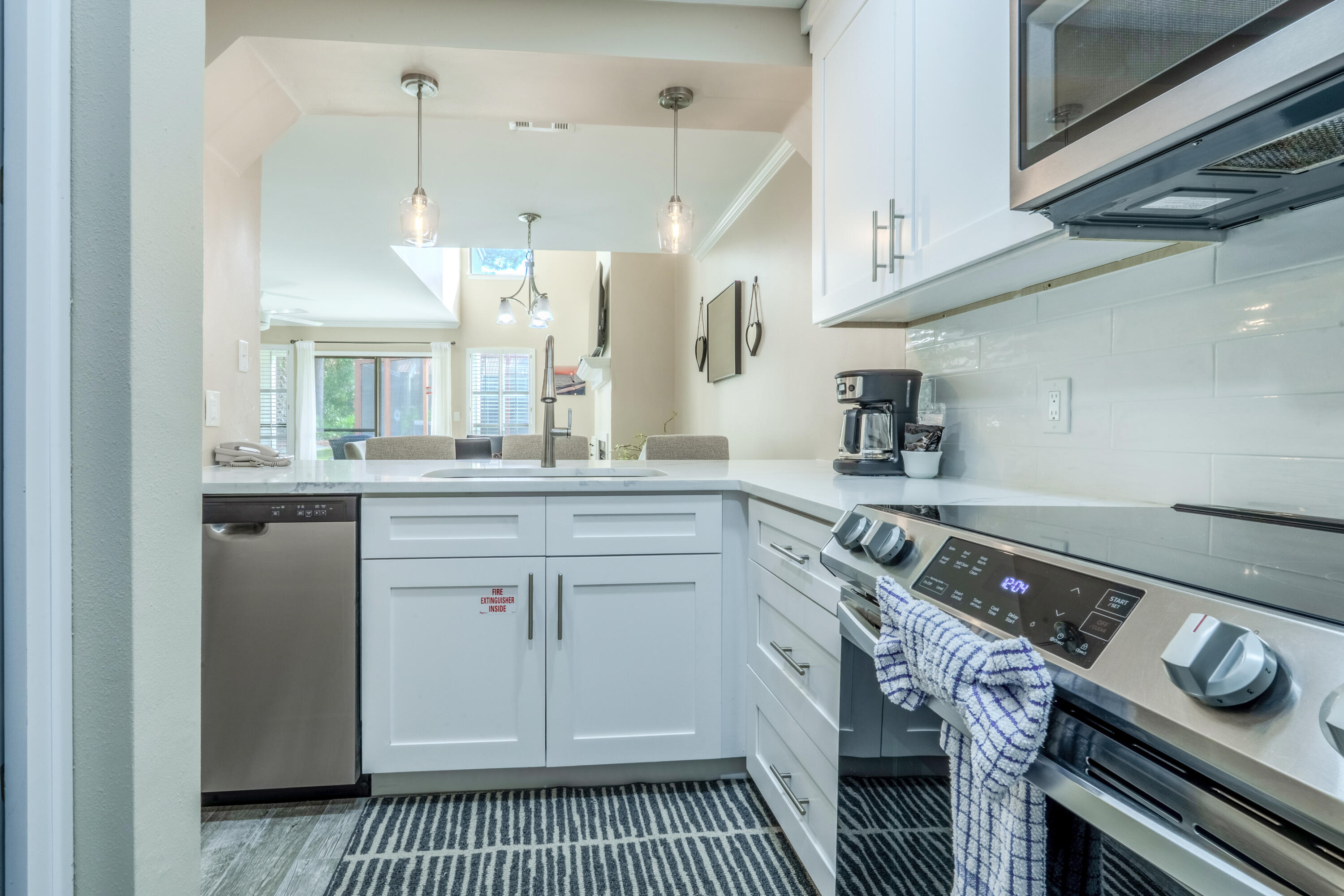 7 Wimbledon Court, Unit 7B Miramar Beach, FL 32550 - Photo 16 of 46 a kitchen with a sink stove and cabinets