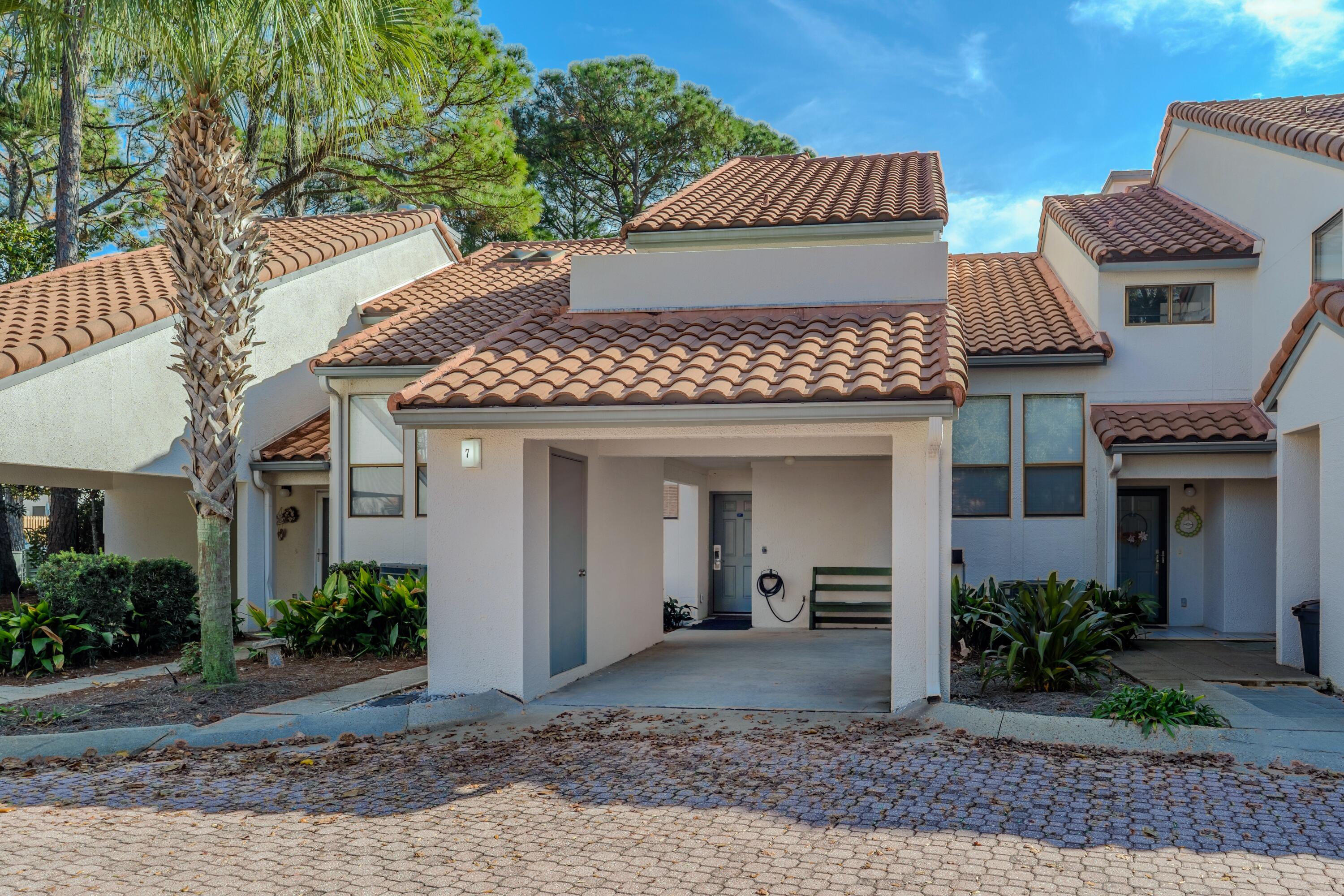 7 Wimbledon Court, Unit 7B Miramar Beach, FL 32550 - Photo 2 of 46 a front view of a house with garden