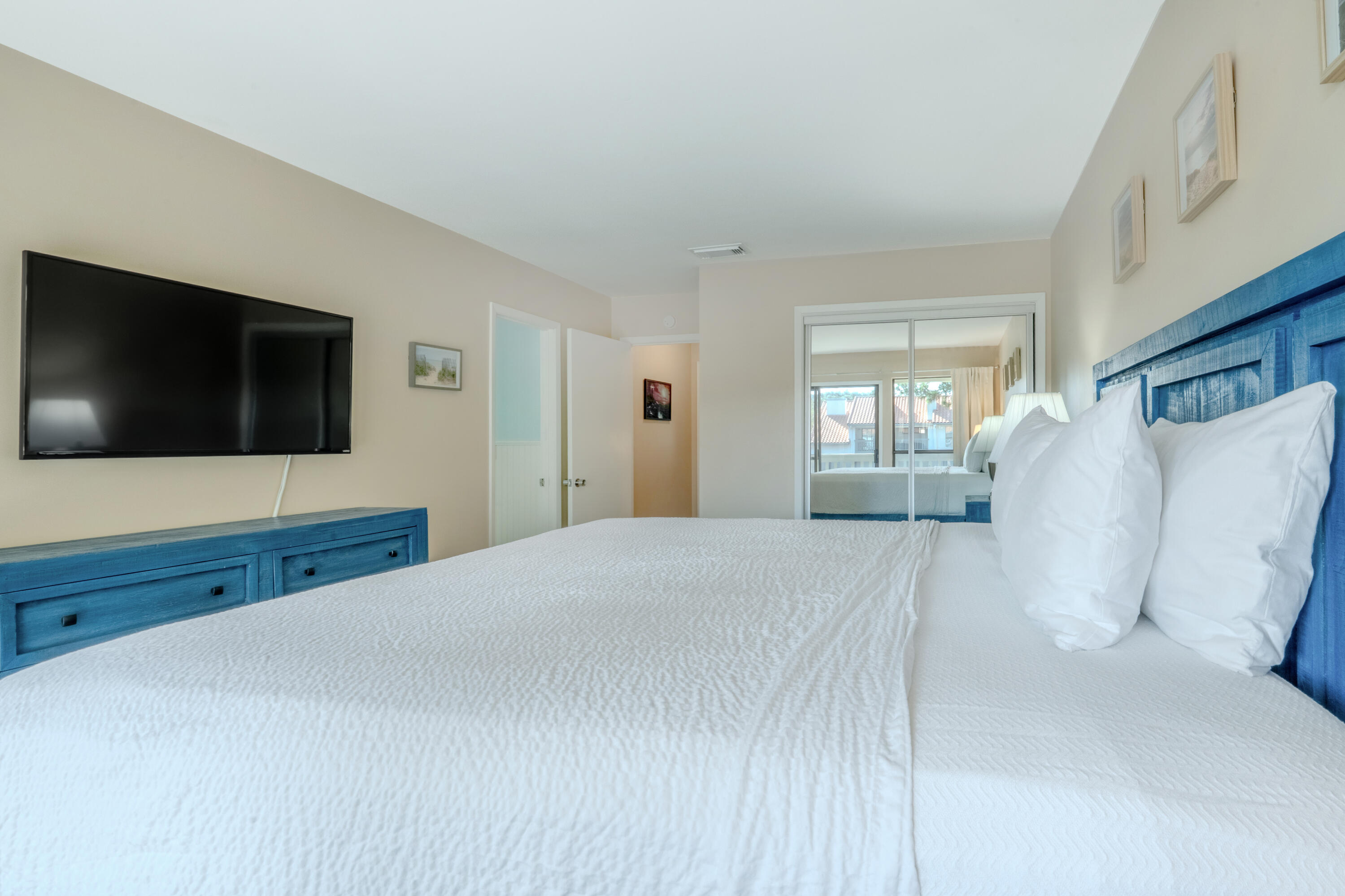 7 Wimbledon Court, Unit 7B Miramar Beach, FL 32550 - Photo 23 of 46 a bedroom with a bed and a flat screen tv
