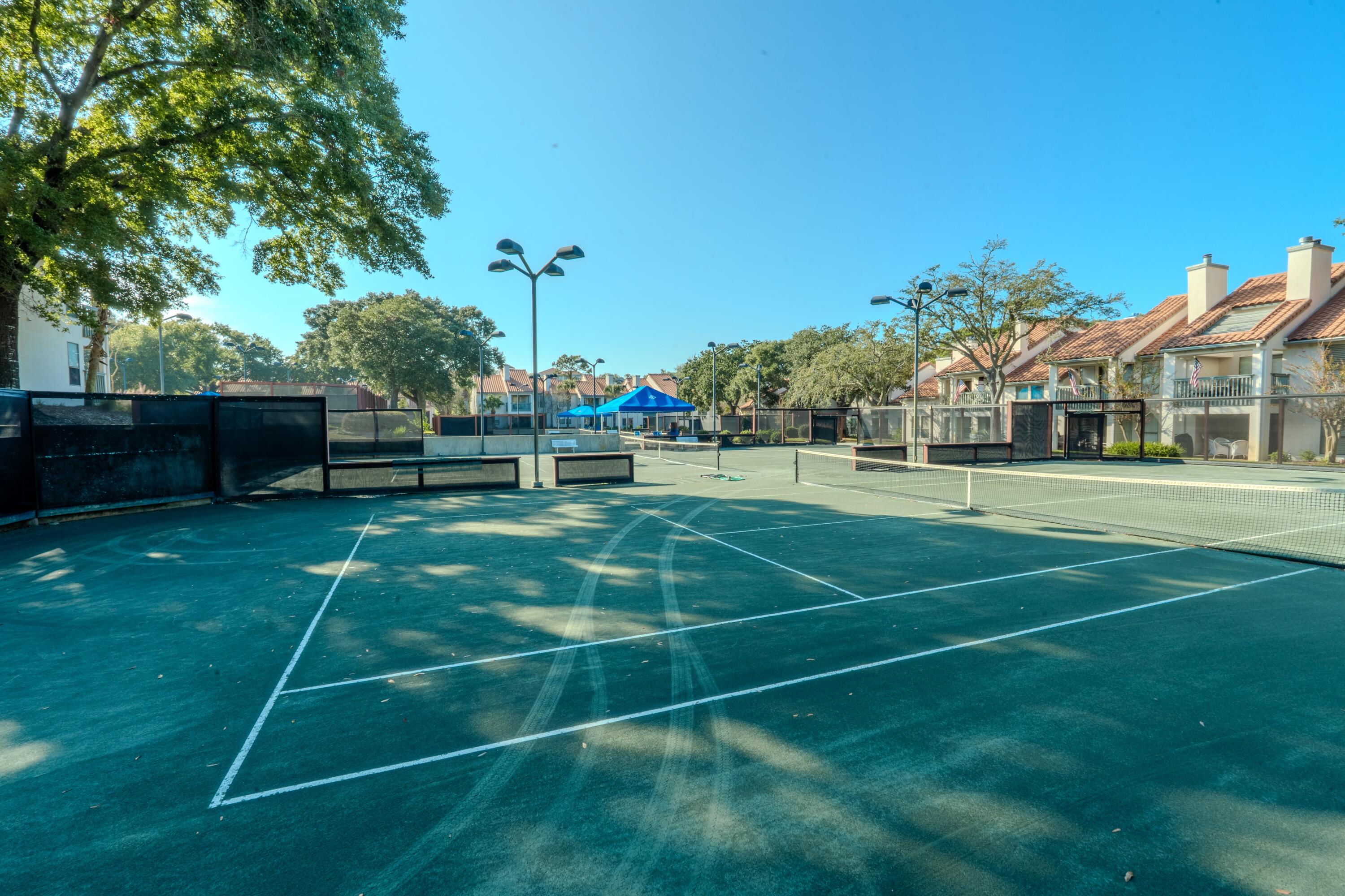 7 Wimbledon Court, Unit 7B Miramar Beach, FL 32550 - Photo 45 of 46 a view of a tennis ground with large trees