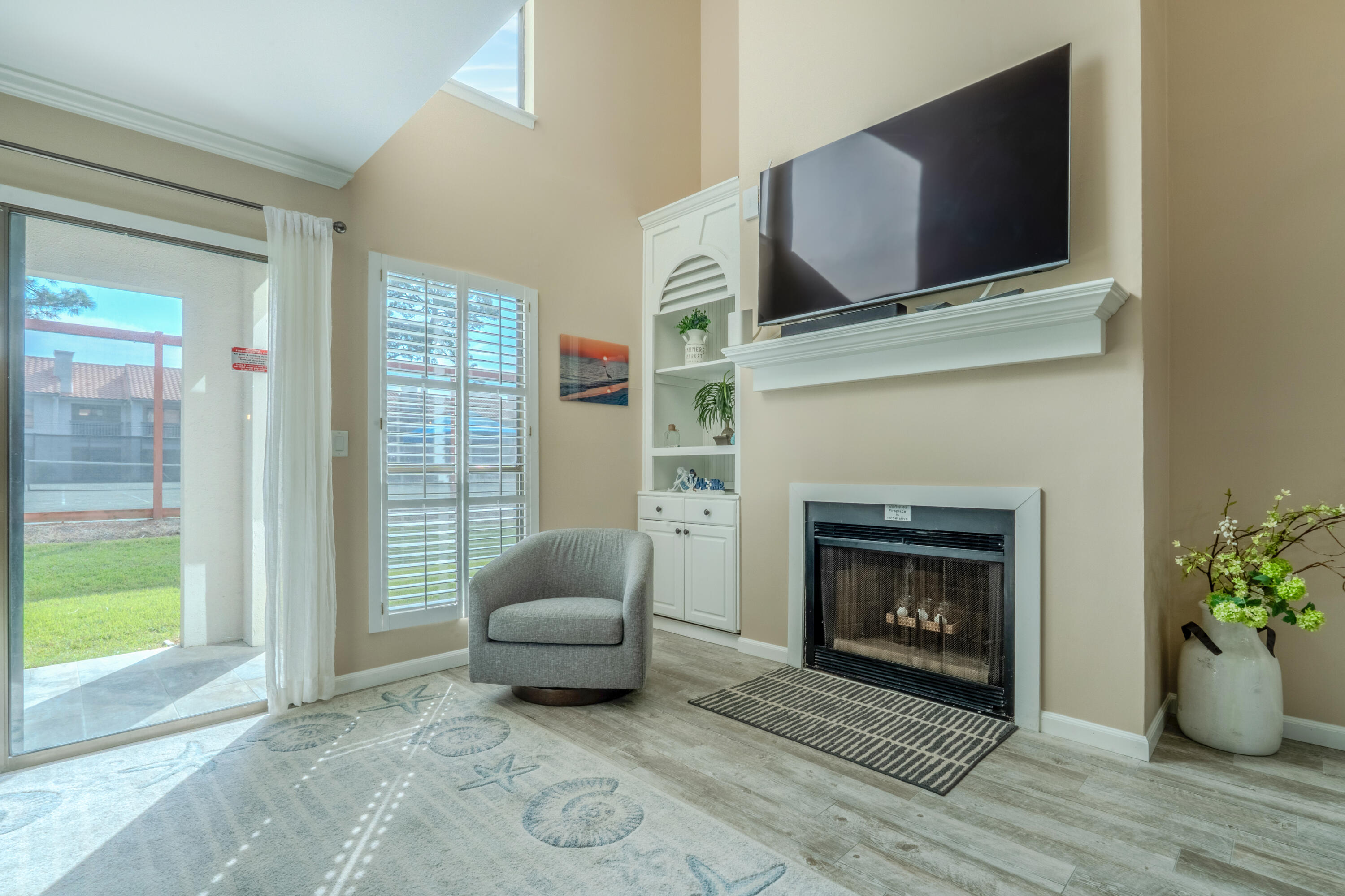 7 Wimbledon Court, Unit 7B Miramar Beach, FL 32550 - Photo 5 of 46 a living room with furniture and a fireplace