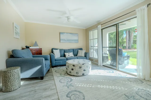 a bedroom with furniture and a large window