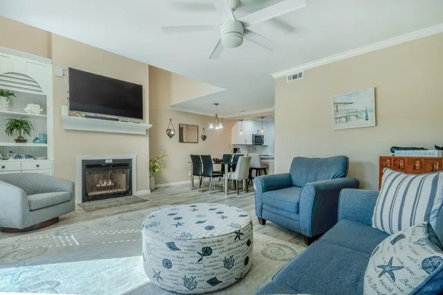 a living room with furniture fireplace and flat screen tv