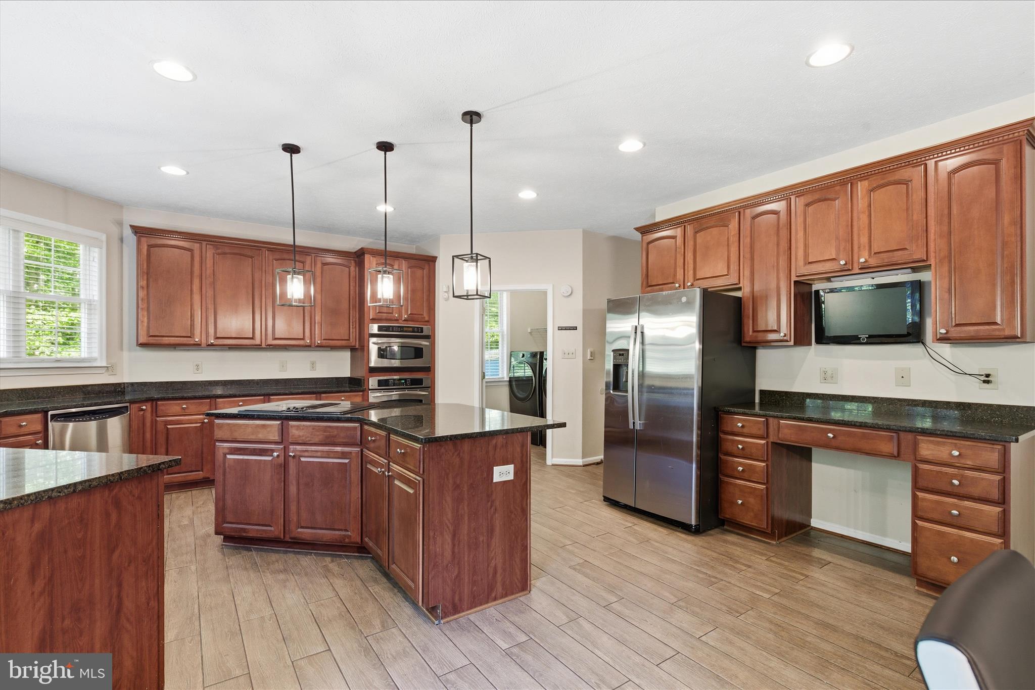 5829 Lockmere Place Waldorf, MD 20601 - Photo 16 of 54 a kitchen with stainless steel appliances granite countertop a refrigerator a stove top oven a sink and dishwasher with wooden floor