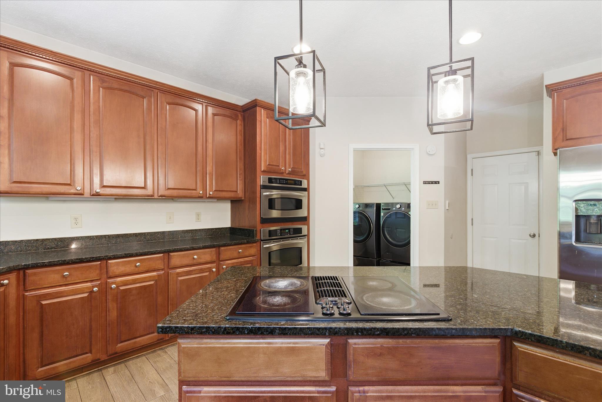 5829 Lockmere Place Waldorf, MD 20601 - Photo 18 of 54 a kitchen with stainless steel appliances granite countertop a sink a stove and cabinets