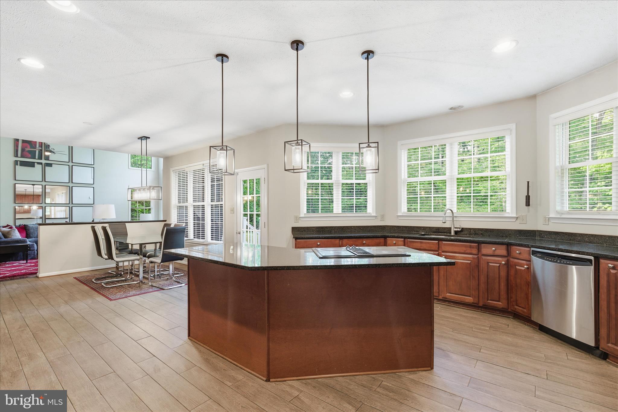 5829 Lockmere Place Waldorf, MD 20601 - Photo 21 of 54 a kitchen with stainless steel appliances granite countertop a sink and wooden floors