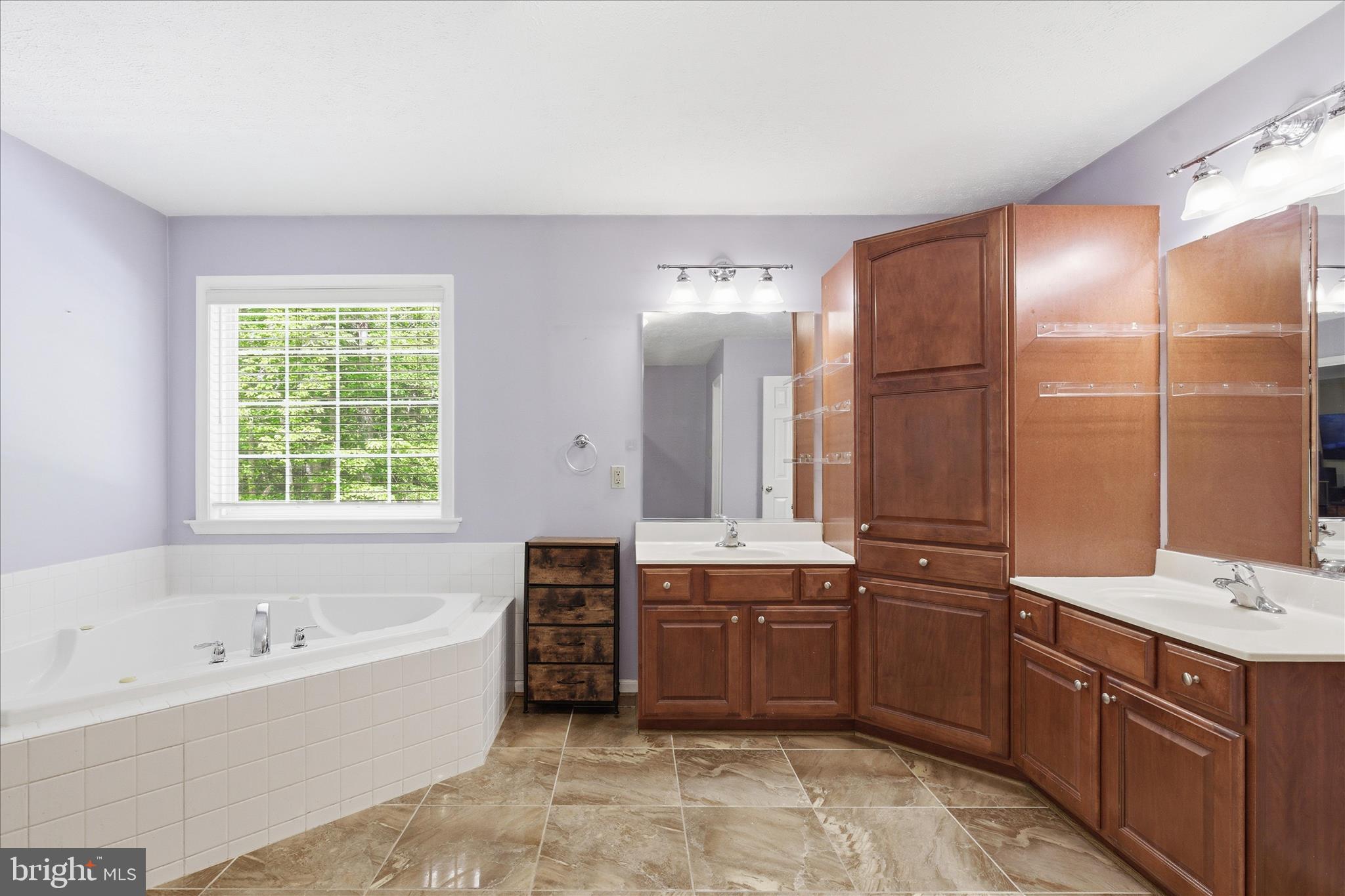 5829 Lockmere Place Waldorf, MD 20601 - Photo 26 of 54 a bathroom with a tub sink shower and mirror
