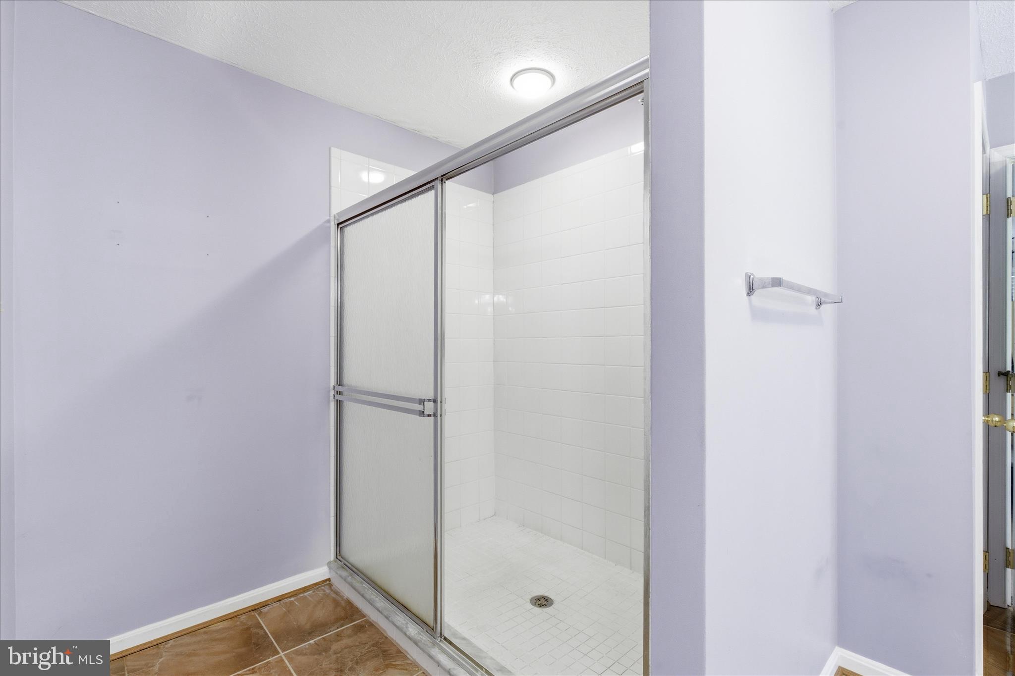 5829 Lockmere Place Waldorf, MD 20601 - Photo 38 of 54 a bathroom with a glass shower door