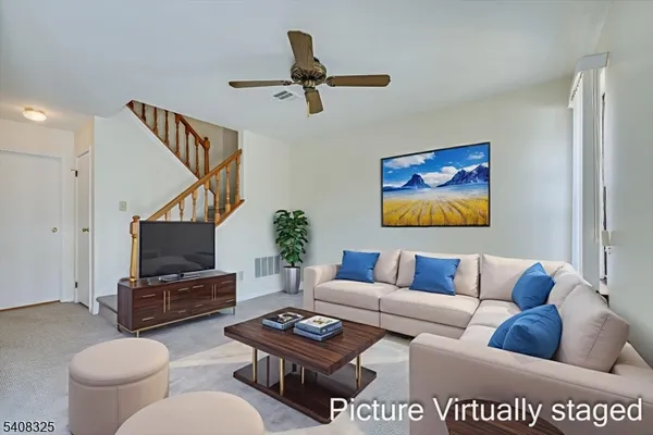 a kitchen with stainless steel appliances a stove a refrigerator a sink dishwasher with a dining table and chairs
