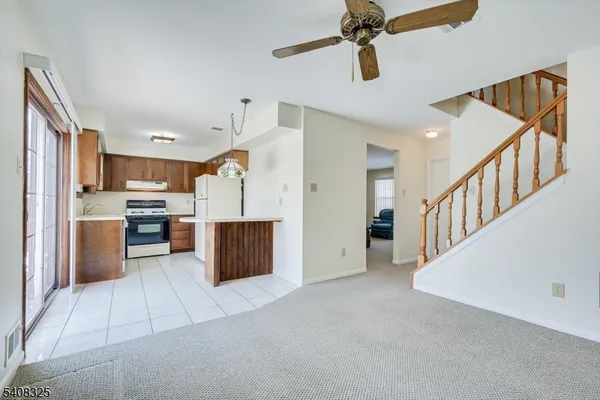 a kitchen with a stove a refrigerator and a sink