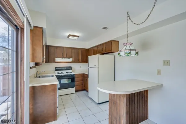 a kitchen with a sink a stove and refrigerator