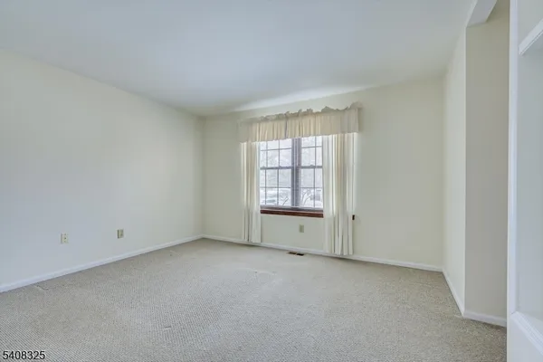 a view of an empty room and closet area