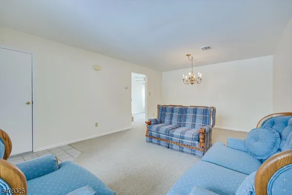 a room with chandelier fan and windows
