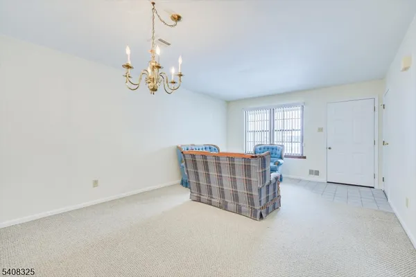 a living room with furniture and chandelier