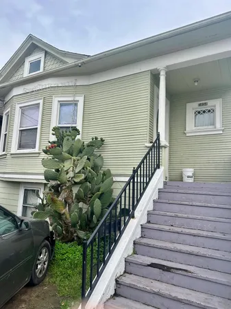 a view of a house with more windows and flower plants