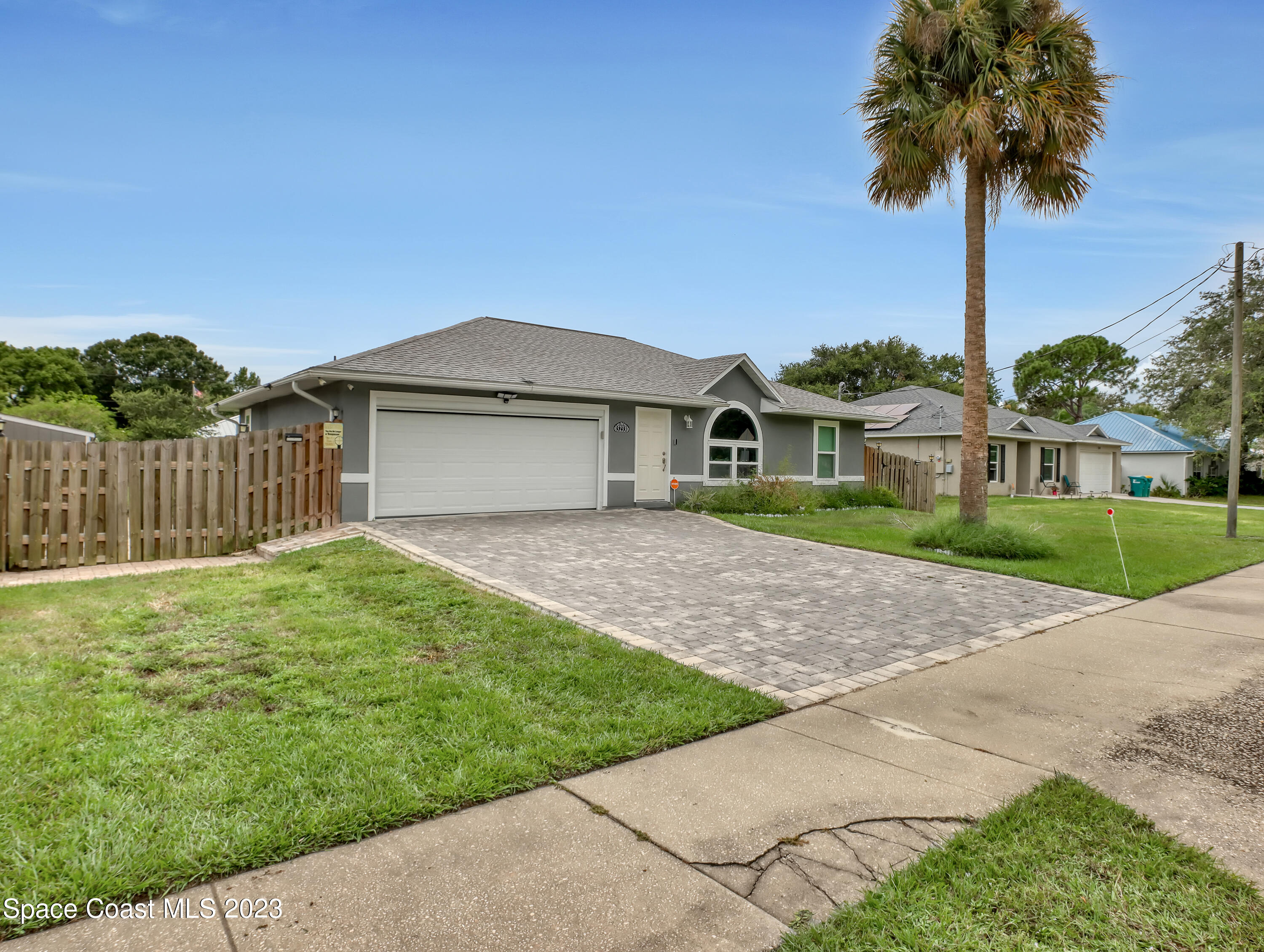 5233 Carrick Road Cocoa, FL 32927 - Photo 1 of 32 a front view of a house with a garden and yard