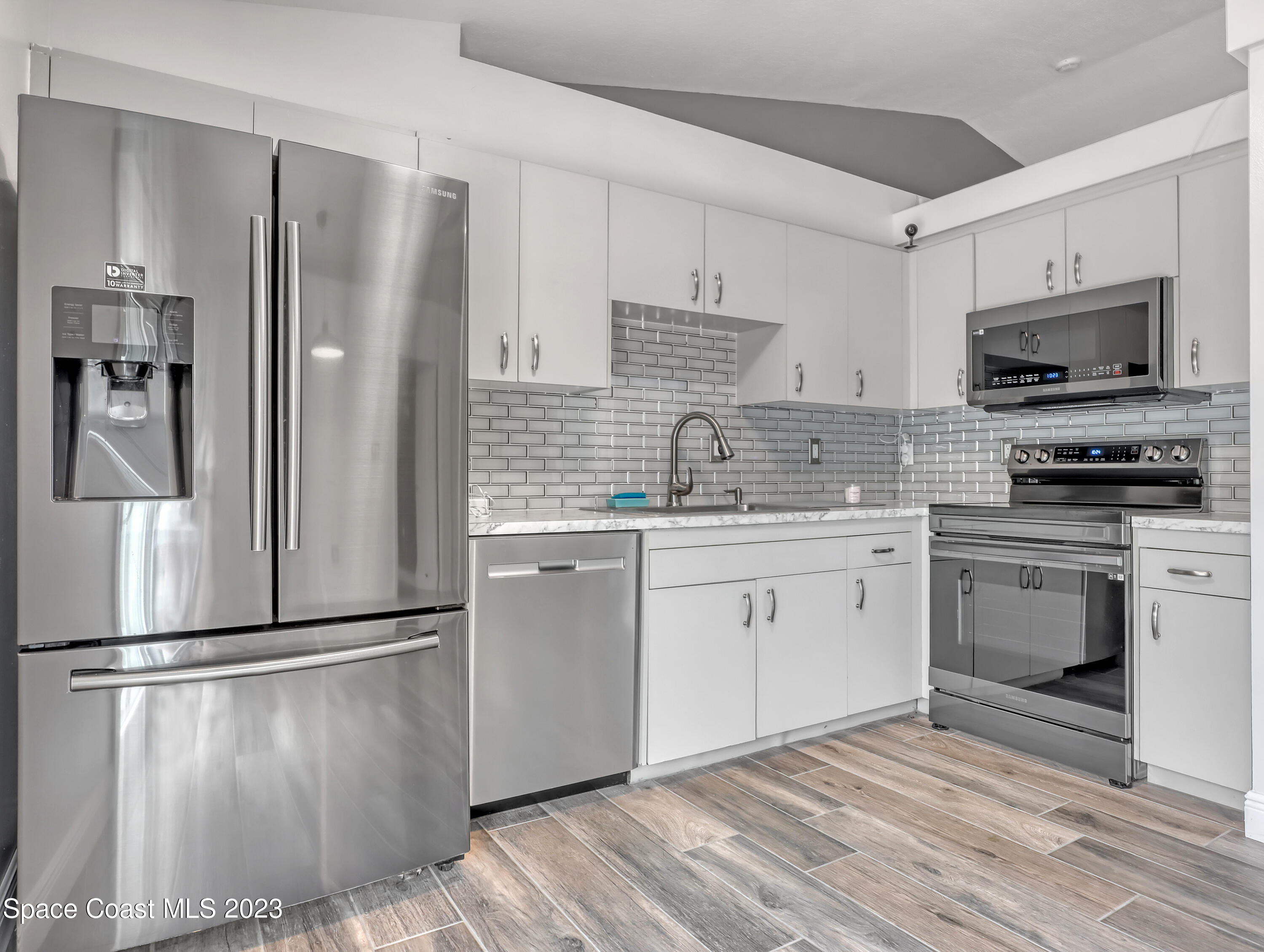 5233 Carrick Road Cocoa, FL 32927 - Photo 11 of 32 a kitchen with a refrigerator stove and sink