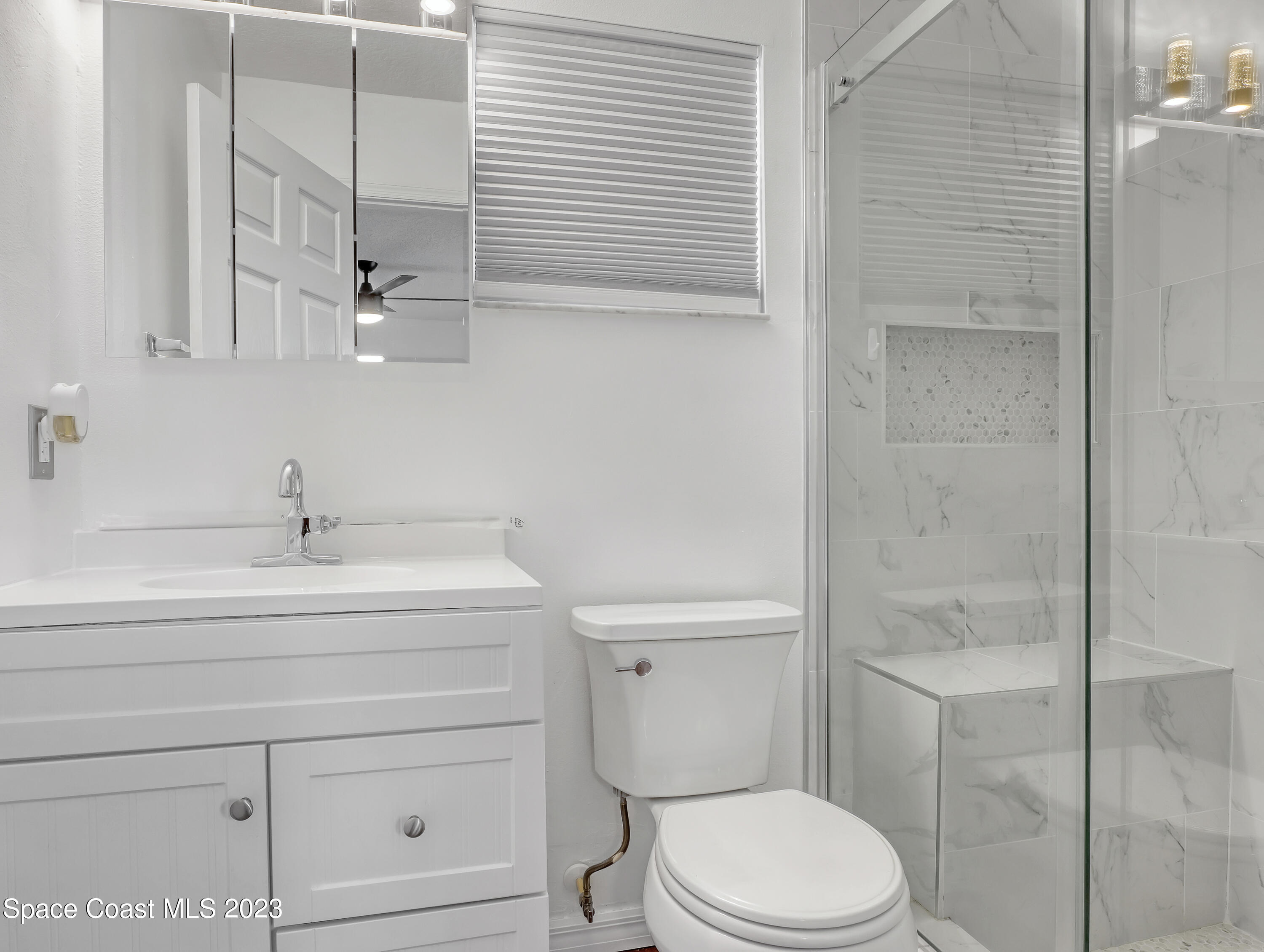 5233 Carrick Road Cocoa, FL 32927 - Photo 15 of 32 a bathroom with a sink a toilet and shower